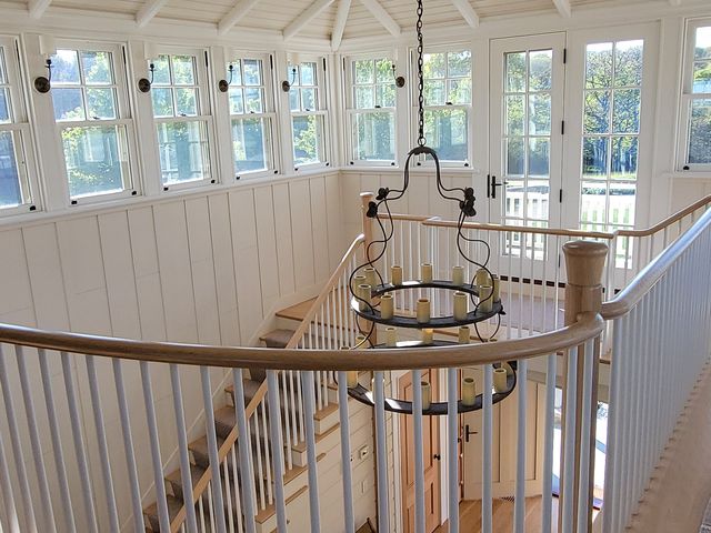 Paneled ceiling, chandelier and stair railing