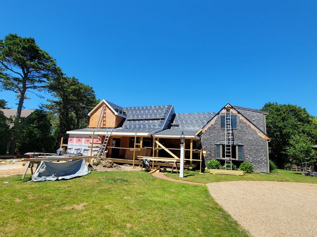 House with new roof underlayment, seen from the yard