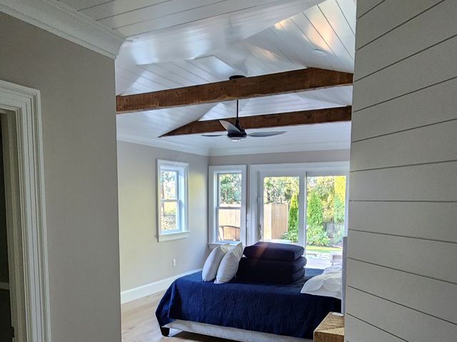 Sitting room with beamed ceiling and shiplap