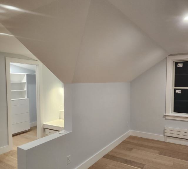 Attic room with built-in shelving