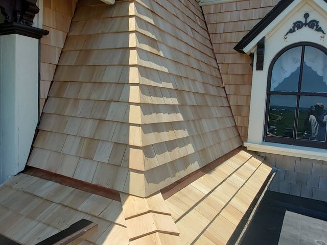 New wood shingles on a wall and dormer