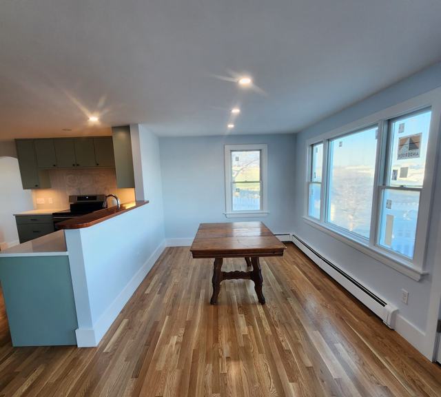 Open kitchen and dining area with hardwood floors