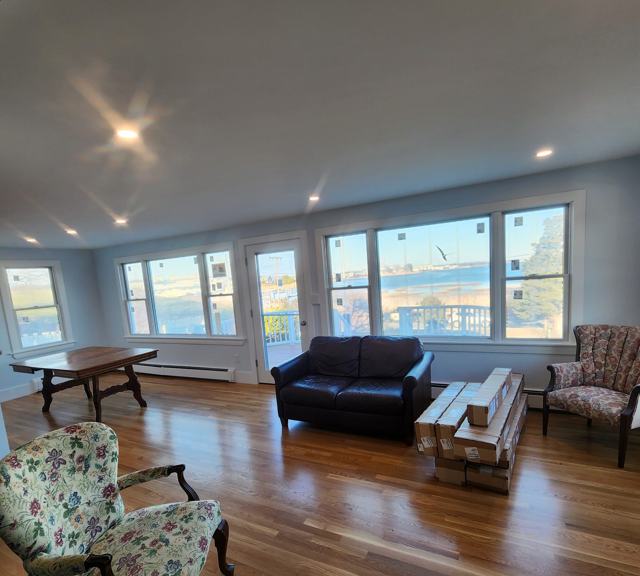 Living room with new hardwood floors and water views
